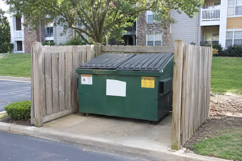 Apartment dumpster enclosure with closed lids
