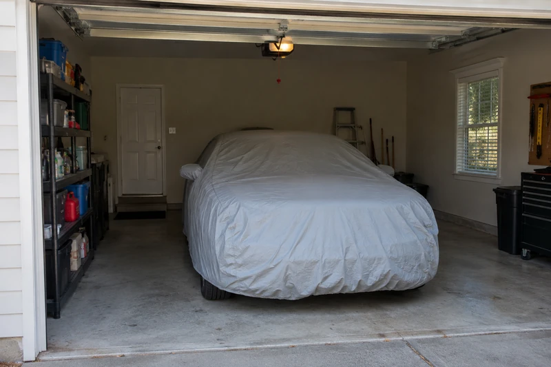 Covered car stored in a garage
